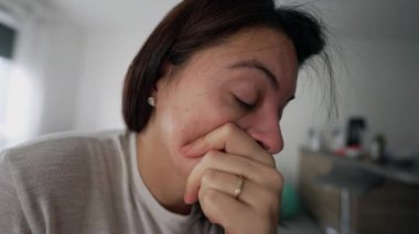 One anxious woman suffering from mental problems and anxiety at home indoors. Extreme close up of lonely guilty female person feeling despair