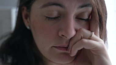 Worried woman with thoughtful expression. Depressed person thinking about mental problems