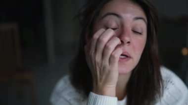One pensive woman scratching face at home while thinking about life staring out apartment window