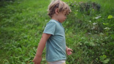 Child hiking outdoors. One active small boy exercising in nature