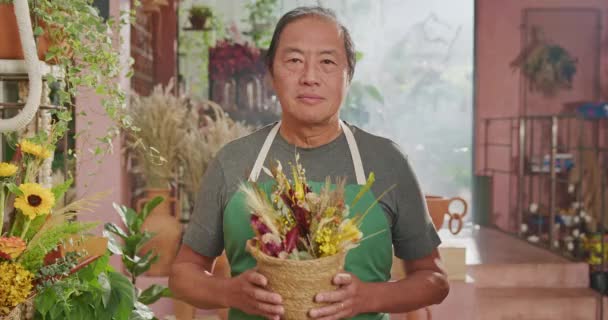 Jeden Japonců Středního Věku Stojí Květinářství Drží Rostlinu Ruce Šťastný — Stock video