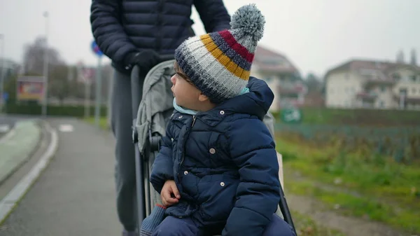 Parent Pushing Child Seated Stroll City Sidewalk Kid Wearing Winter — Foto Stock