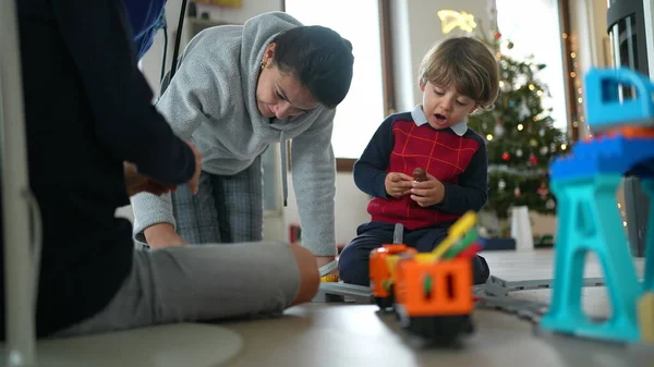 Children playing with toys in Christmas morning after opening presents. Kids play with gifts