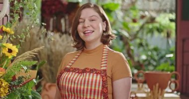 Portrait of a woman wearing apron smiling at camera closeup face.