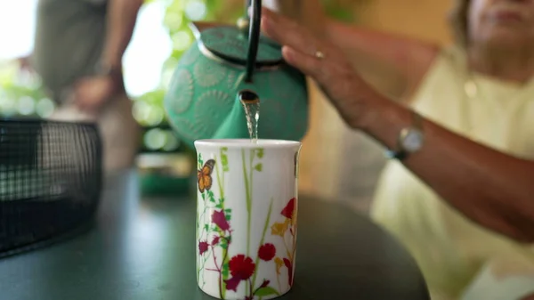 Nahaufnahme Person Die Tee Tasse Serviert Seniorin Hält Gusseiserne Teekanne — Stockfoto