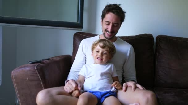 Playful Dad Son Relationship Child Seated Father Lap Couch Home — Stock Video