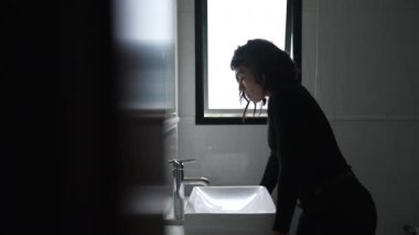 Banyodaki aynanın önünde duran İspanyol bir kadın. Güney Amerikalı Latin kız korkularla yüzleşiyor