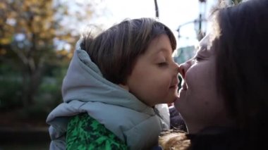 Anne çocuk sevgi ve şefkat. Anne ve oğlu Eskimo öpücüğü yapıyor. Küçük çocuk ailesiyle bağ kuruyor. Çocukluk ebeveynlik yaşam tarzı