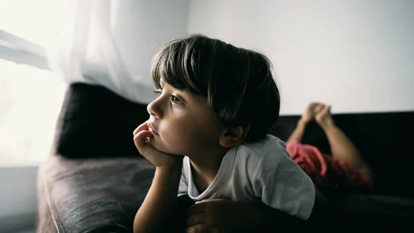One Small Boy Lying Couch Hand Chin Hypnotized Entertainment Media — Foto Stock