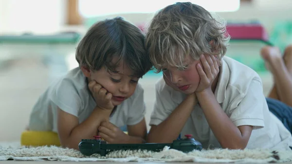 Two Children Watching Media Screen Lying Floor Candid Portrait Brothers — Foto Stock