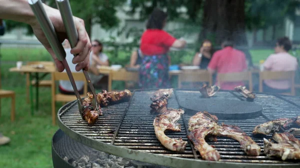 Friends Gathered Barbecue Party Close Hand Holding Clamp Preparing Meat —  Fotos de Stock