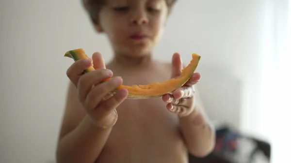 One Small Boy Devouring Yellow Melon Fruit Indoors Portrait Face — Stok fotoğraf