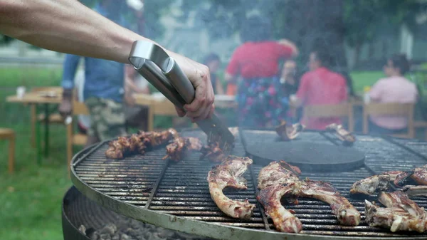 Friends Gathered Barbecue Party Close Hand Holding Clamp Preparing Meat — 图库照片