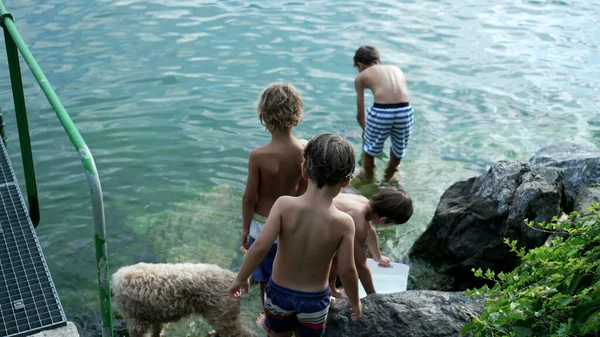 休暇中に湖の水で小さな男の子 水着を着て屋外で自然を楽しむ子供たち 釣りが楽しい子供 — ストック写真
