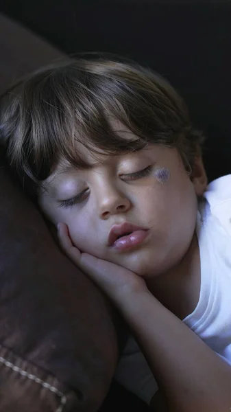 One little boy sleeping on couch. Child asleep napping on sofa portrait face close up
