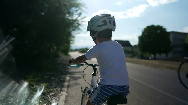 Back Child Learning Ride Bike Wearing Helmet Bicycle Urban Road — Stock Photo, Image