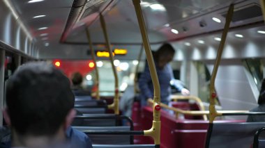 Otobüsün arkasında geceleri işten işe gidip gelen insanlar var. Akşamları ulaşımdan çıkan kişi