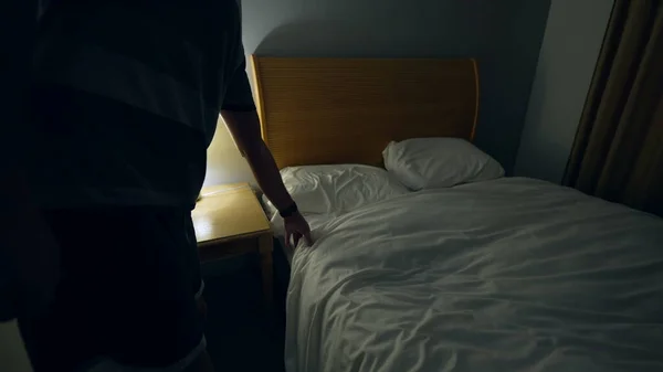 Man Prepares Bed Sleep Person Lays Bed Turns Night Stand — Stock fotografie