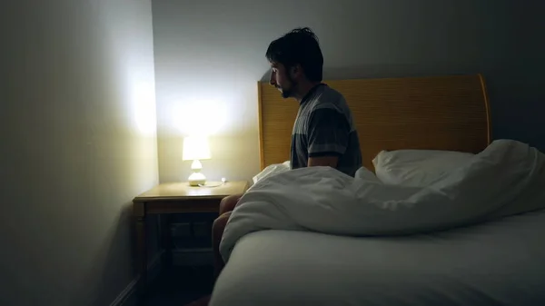 Man Prepares Bed Sleep Person Lays Bed Turns Night Stand — Foto Stock