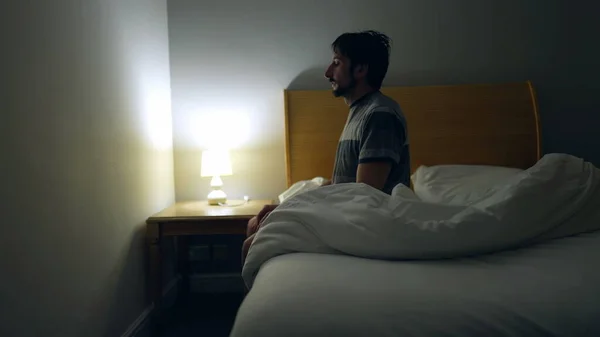 Man Prepares Bed Sleep Person Lays Bed Turns Night Stand — Photo