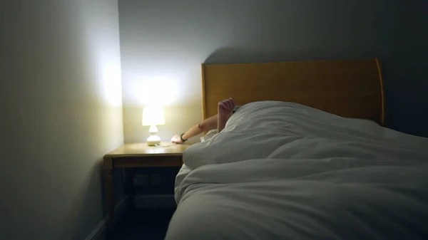 Man Prepares Bed Sleep Person Lays Bed Turns Night Stand — Foto de Stock
