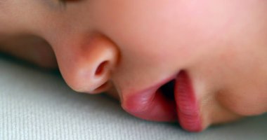 Closeup baby face sleeping, infant eyes closed macro details