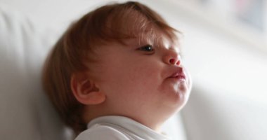 Cute baby one year old toddler portrait, infant child face observing