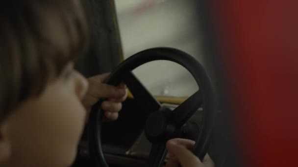 Child Hands Holding Steering Wheel Pretending Driving Amusement Park Carousel — Stock Video