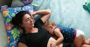 Sleeping mother and baby together during afternoon nap