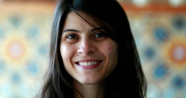 Portrait of attractive 30 year old woman talking to camera