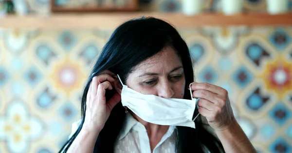 Latina hispanic older woman wearing covid-19 face mask virus pandemic prevention