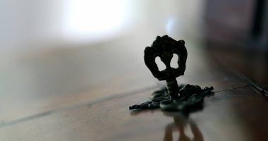 Close-up hand inserting key in antique furniture