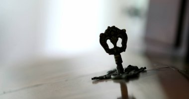 Hand inserting key in antique furniture. Close-up person removes key
