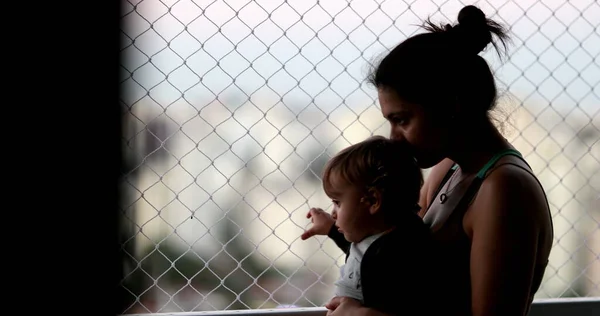 Pensive Mother Holding Baby Balcony Window Looking — Φωτογραφία Αρχείου