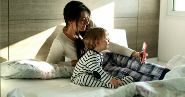 Mother and baby child in video chat with family on cellphone device