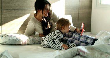 Mother and baby child in video chat with family on cellphone device
