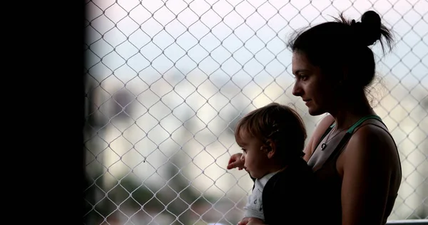 Pensive Mother Holding Baby Balcony Window Looking — Zdjęcie stockowe