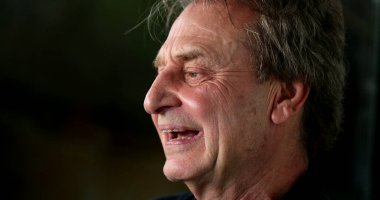 Thoughtful older man smiling and laughing. Pensive senior person smile and laugh