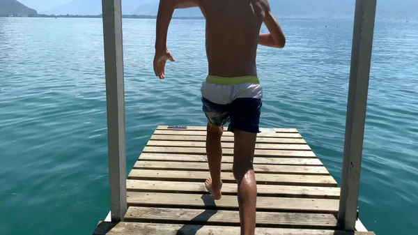 Młody Chłopiec Biegający Pluskający Się Wody Jeziora Dzieciak Biega Molo — Zdjęcie stockowe