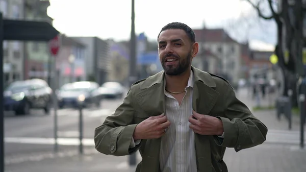 stock image One confident Moroccan man walking in city. Tracking shot in motion of an Arab male person in urban environment smiling