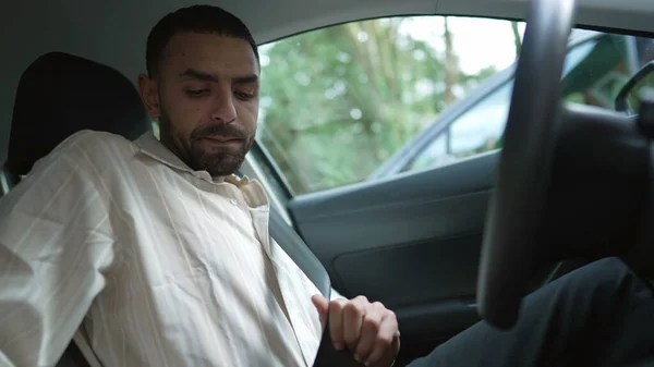 stock image One Arab man putting seatbelt on and drives off. A Middle Eastern male driver sitting inside vehicle and driving