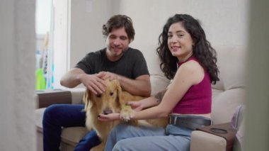 Mutlu çift evde labrador köpeğiyle eğleniyor. 