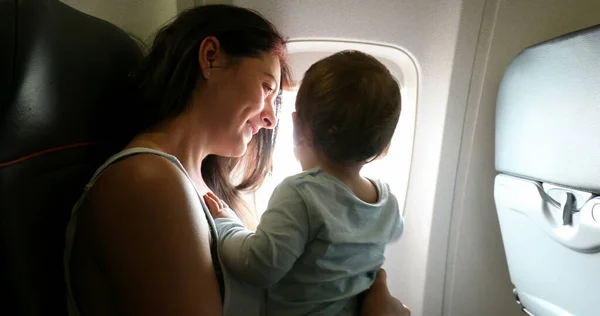 Mother Holding Baby Airplane Parent Infant Child Traveling Commercial Plane — Stok fotoğraf