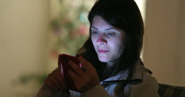 stock image Authentic real life candid woman using smartphone device at night