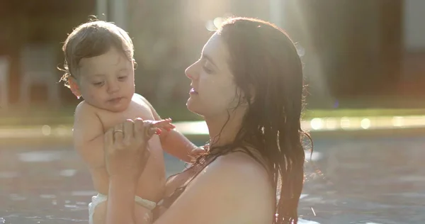 Mother Caring Baby Swimming Pool Kissing Cheek Mom Kisses Toddler — Stock fotografie