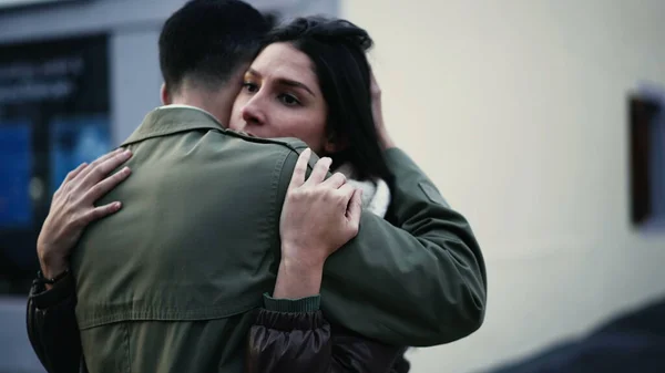 stock image Young Arab man embracing woman standing in city street in empathy. Tracking shot of an affectionate compassionate couple. relationship support and gratefulness concept