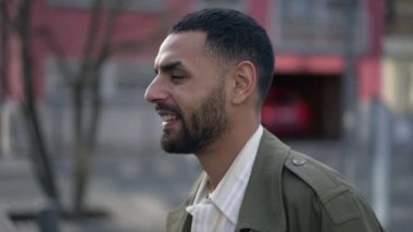 Halinden memnun bir Arap şehirde geziniyor. Düşünceli bir Orta Doğulu erkeğin ceketli bir portreyi yakından çekerken görüntüsü.