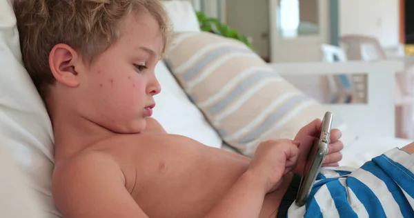 Child Toddler Holding Smartphone Lying Home Sofa — Stock Fotó