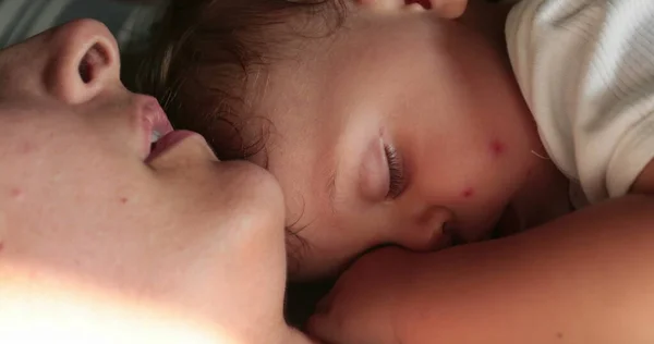 stock image Candid real life mother asleep napping with baby infant toddler child