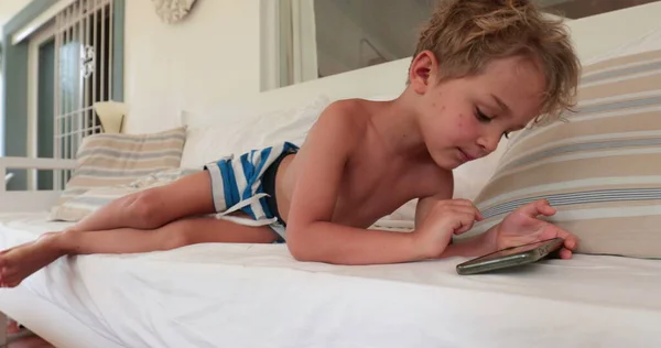Casual Little Boy Child Using Cellphone Lying Sofa — 스톡 사진
